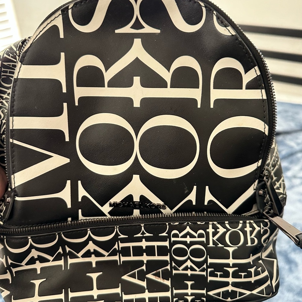 Michael Kors, backpack purse, gently used black and white logos covering it